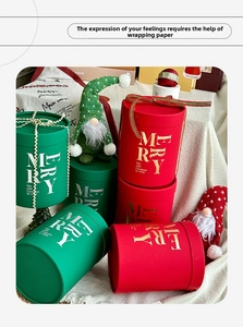 Detail of red and green Christmas cylinder gift boxes with gold foil Merry Christmas prints