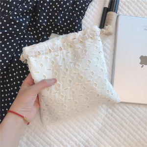 Detail of white lace drawstring bag with diamond embroidery for jewelry storage