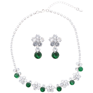 Luxurious silver necklace and earring set with green flower zircons on white background