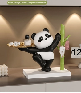 Macro detail of cute panda organizer with a gold storage tray and bamboo shaped rack