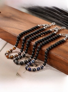 Men's natural tiger eye and lapis lazuli stone beaded bracelets on vintage display