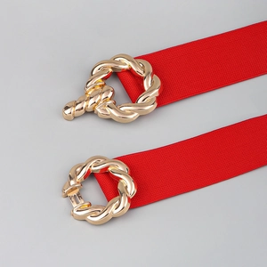 Detail view of red elastic waist belt with gold twisted round buckle in open and closed state