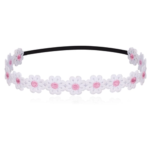Close-up of white daisy embroidery on a black elastic baby headband with detailed stitching