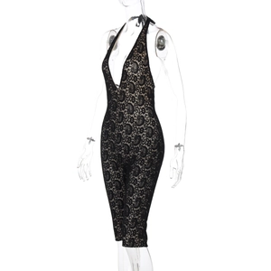 Detail view of black lace halter jumpsuit featuring intricate floral patterns and deep V-neck