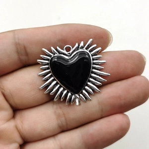Gothic silver sunburst metal pendant with a black heart center for jewelry making