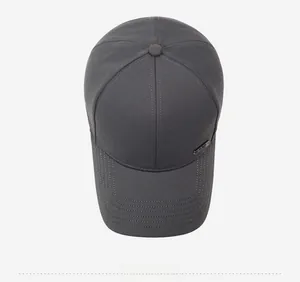 Top view of dark grey baseball cap showing six-panel crown and metal logo plate