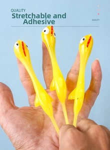 Close-up showing hand stretching yellow TPR rubber slingshot chicken toy for fun