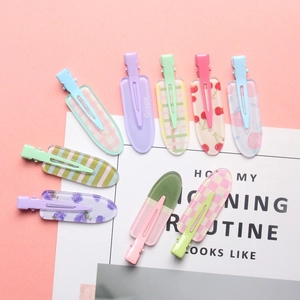 Detailed view of colorful printed acrylic hair clips featuring cherry and plaid patterns