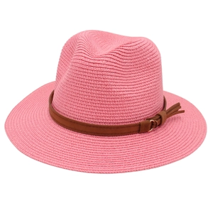 Detail of pink straw Panama hat with woven texture and brown leather belt trim