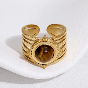 Detailed macro view of 18k gold-plated stainless steel ring with round tiger eye stone