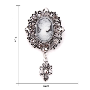 Macro view of vintage silver cameo brooch with rhinestones and size dimensions