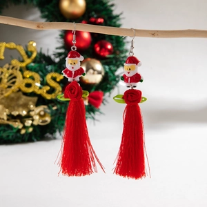 Detail of long tassel earrings with Santa Claus, red flowers, and beaded holiday charms