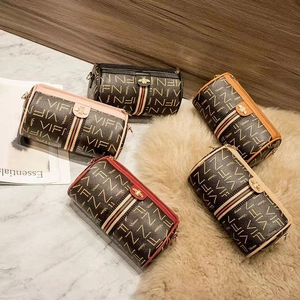 Group display of cylinder makeup bags in five colors with bee charms and VIFN prints