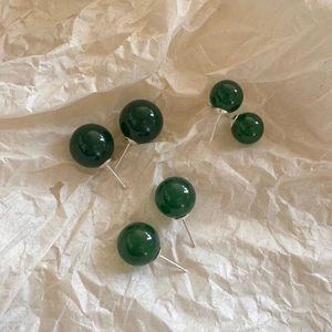 Macro detail of dark green agate bead earrings with 925 sterling silver studs