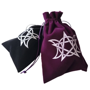 Detail view of black and purple velvet drawstring pouches with silver triple moon symbol