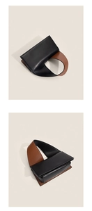 Detail of color-block minimalist handbag featuring premium black and brown leather finish