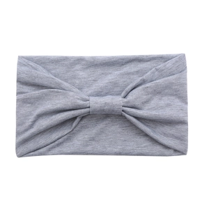 Grey cotton yoga headband with a stylish knotted bow design on a white background