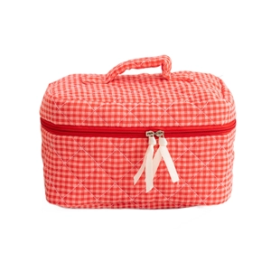 Quilted red checkered cosmetic bag with handle and white ribbon zippers on white background