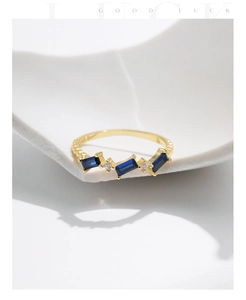 Detail of S925 silver gold-plated ring with blue stones and S925 hallmark