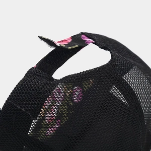 Black mesh trucker hat with peony floral pattern details and adjustable strap back