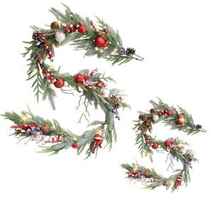 Lighted Christmas garland with pine cones, red berries and snow-covered needles