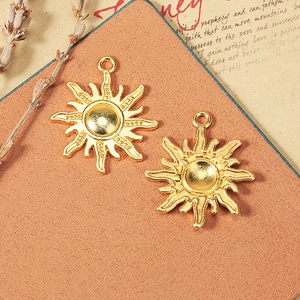 Vintage 25mm golden sun charm pendant with wavy rays and hanging loop for jewelry making