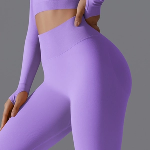 Detail of high-waist purple seamless yoga leggings with ribbed texture and peach lift