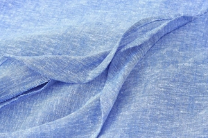 Macro shot of blue linen-blend fabric texture showing detailed natural weave and fiber