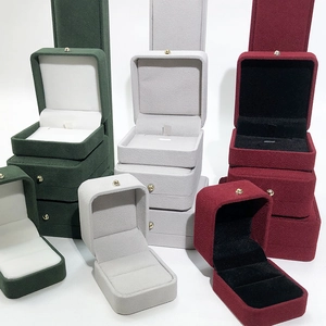 Deep green, burgundy, and gray velvet jewelry boxes with retro gold button clasp details