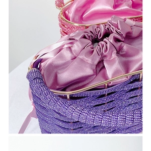 Macro detail of purple and pink rhinestone evening bag with silk satin drawstring liner
