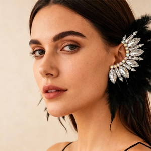 Detail of bohemian crystal ear cuff with elegant black feathers on female model