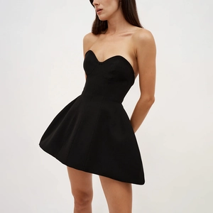 Detail view of the bustier bodice and flared skirt on this black strapless mini dress