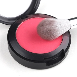 Flame shaped highlight brush with pink powder compact in matte black casing