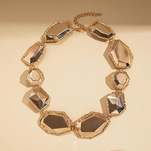 Detail of chunky gold geometric necklace showing the adjustable clasp and mirror finish