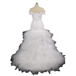 Elegant white mermaid bridal gown with off-shoulder sequined bodice and lace-up back