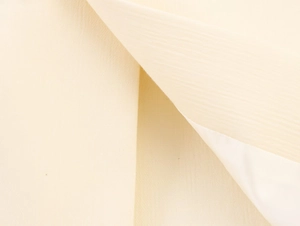 Macro shot of beige woven fabric texture and pleated layers on a longline blazer jacket