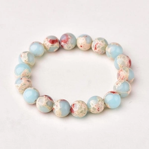 Detail of blue Shoushan stone beaded bracelet with natural red and beige marbled textures