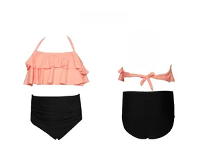Detail of pink ruffled halter top and black high-waisted bikini bottoms for girls