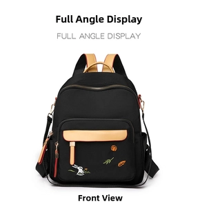 Detailed close-up of nylon backpack with elegant rabbit embroidery and leather accents