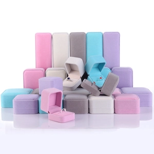 Elegant velvet jewelry boxes for rings and earrings in pink, blue, grey, and purple