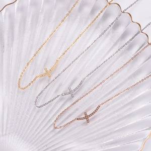 Elegant curved cross necklaces in gold, silver, and rose gold with zircon stones