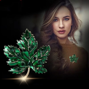 Luxury green enamel maple leaf brooch with sparkling crystals on gold metal trim