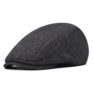 Detailed view of dark grey herringbone wool newsboy cap with orange stripe pattern