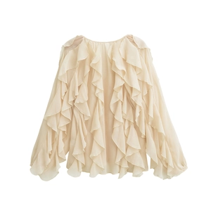 Detailed view of layered chiffon ruffles and delicate fabric texture on a beige blouse