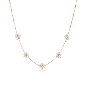 Gold daisy necklace with small pearl flowers and round zircon beads on white background