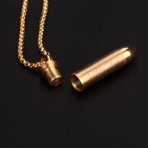 Polished gold bullet pendant necklace with refillable compartment on black background