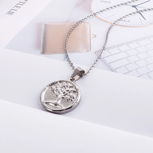 Detailed close-up of a silver stainless steel Tree of Life pendant necklace with relief design