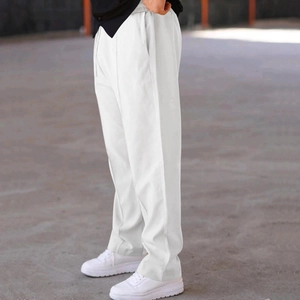 Detail view of white loose straight-leg casual trousers showing side profile and drape