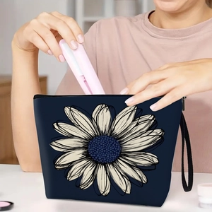 Navy blue floral cosmetic bag with white daisy print and wrist strap for travel