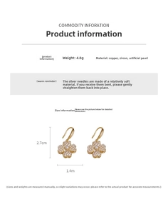Close-up of gold-plated clover earrings featuring cubic zirconia and artificial pearls